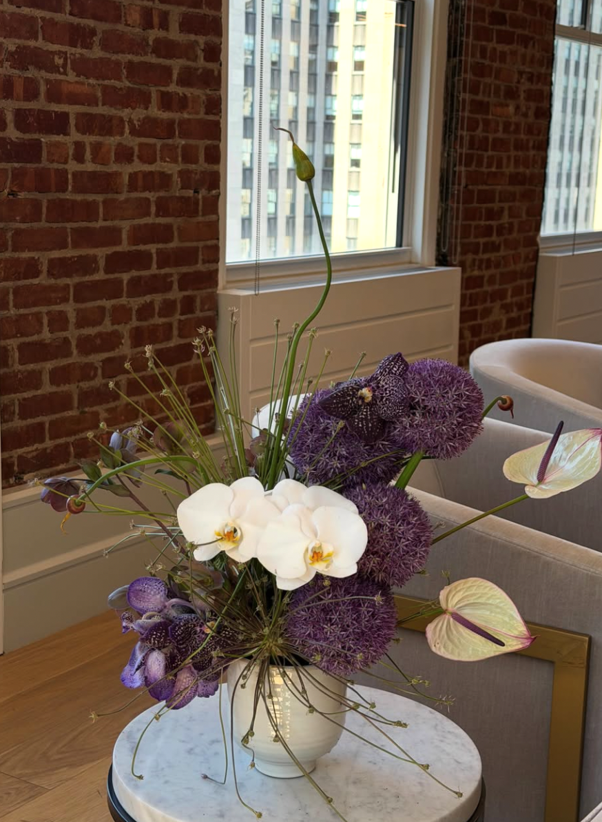Purple allium and white orchid arrangement